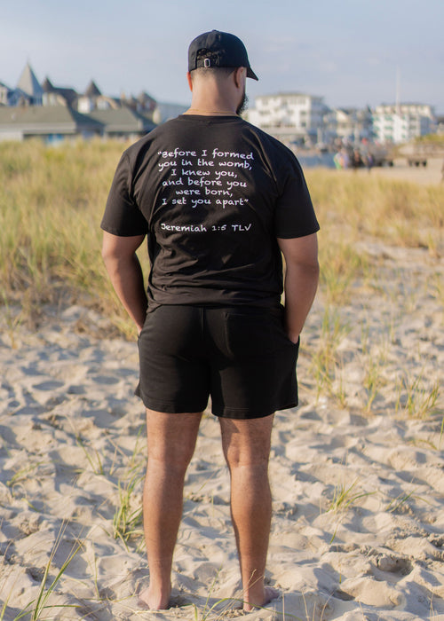 Black organic cotton t-shirt featuring Before I Formed You design inspired by Jeremiah 1:5. Premium Christian streetwear apparel by God of Abraham Adonai declaring purpose, identity, and being set apart in God.