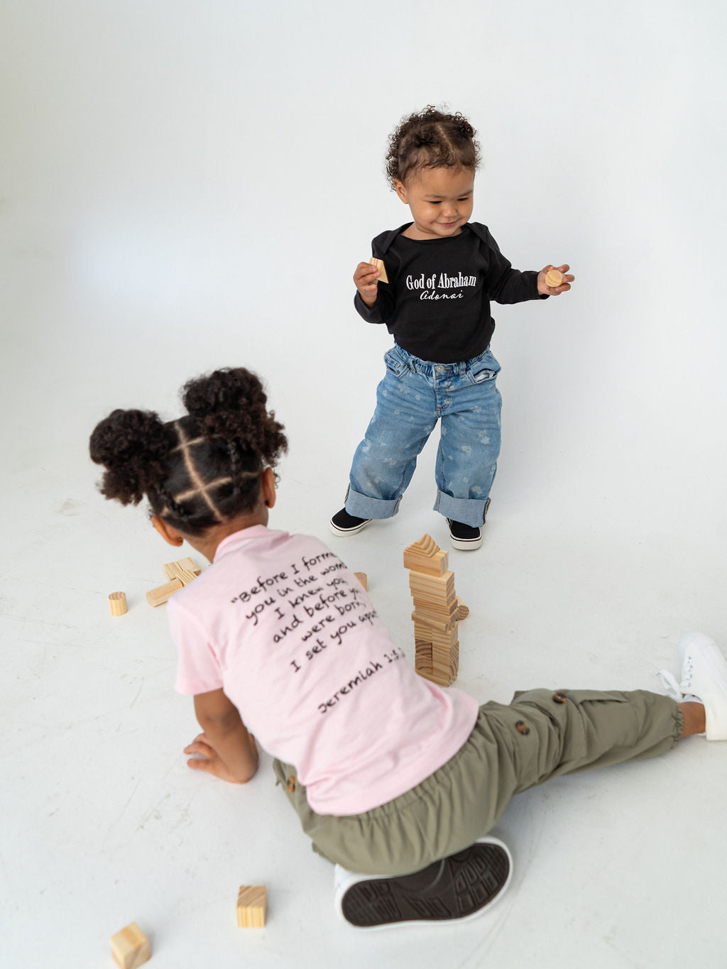 Black organic baby onesie featuring "Before I Formed You" from Jeremiah 1:5, reminding every child they are known by God and created with purpose.