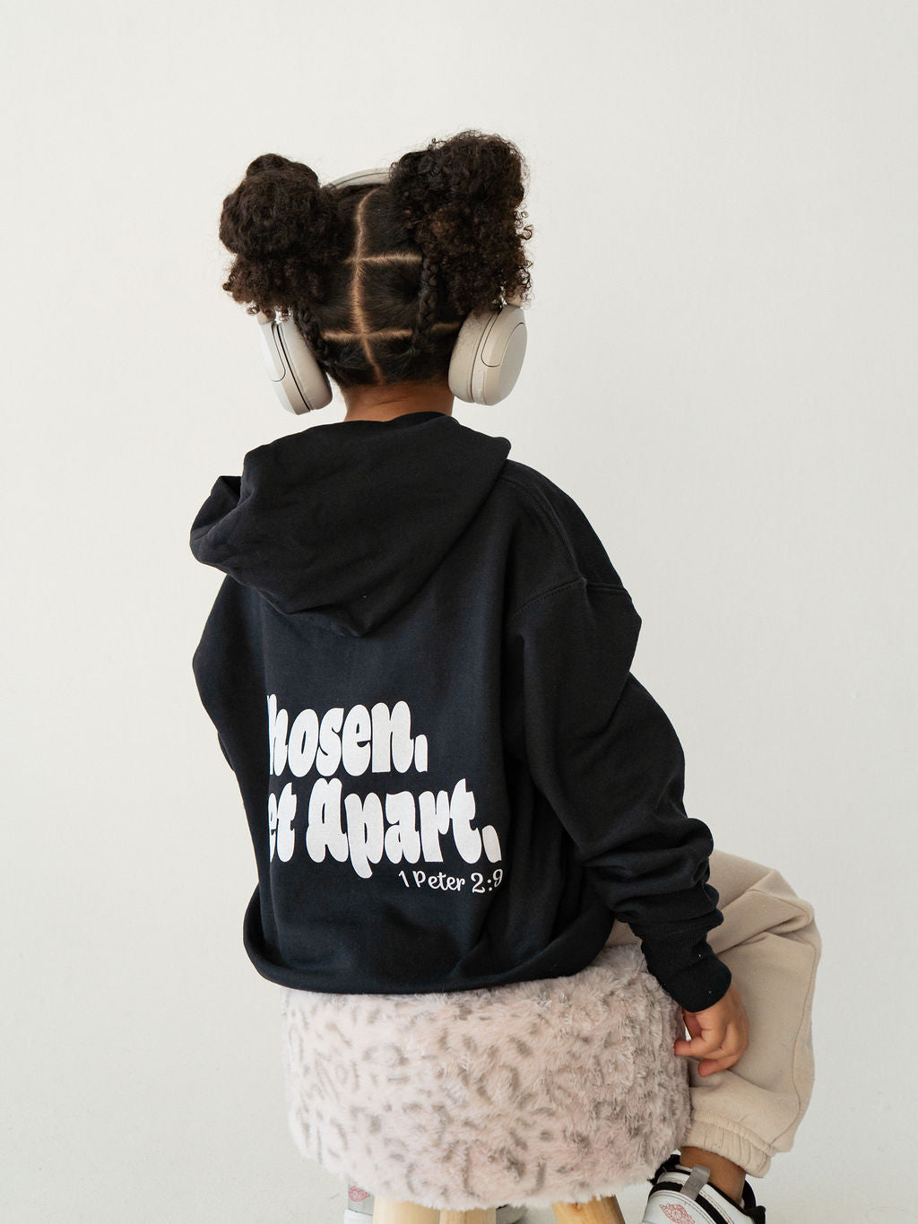 Youth wearing a black Chosen & Set Apart Christian hoodie, reminding children they are chosen by God and set apart with purpose.