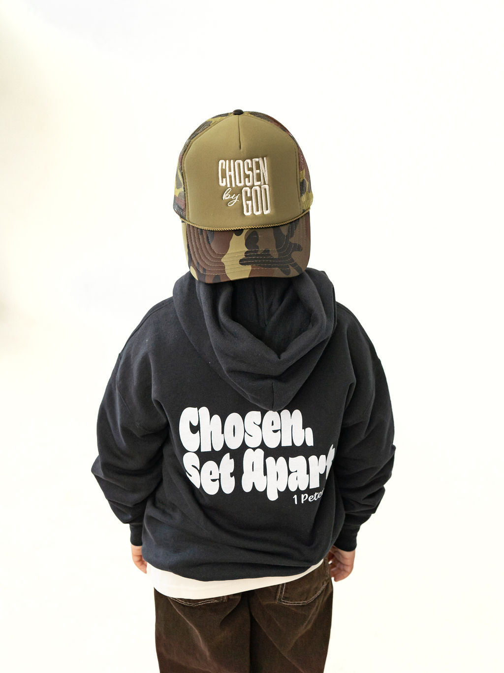 Youth wearing a black Chosen & Set Apart Christian hoodie, reminding children they are chosen by God and set apart with purpose.