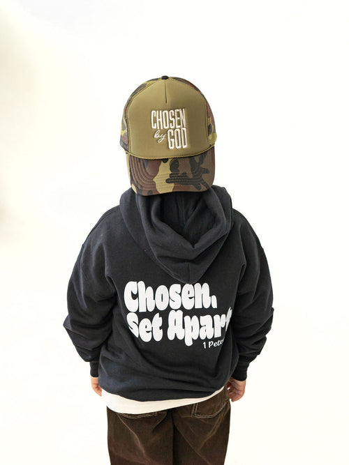 Youth wearing a black Chosen & Set Apart Christian hoodie, reminding children they are chosen by God and set apart with purpose.