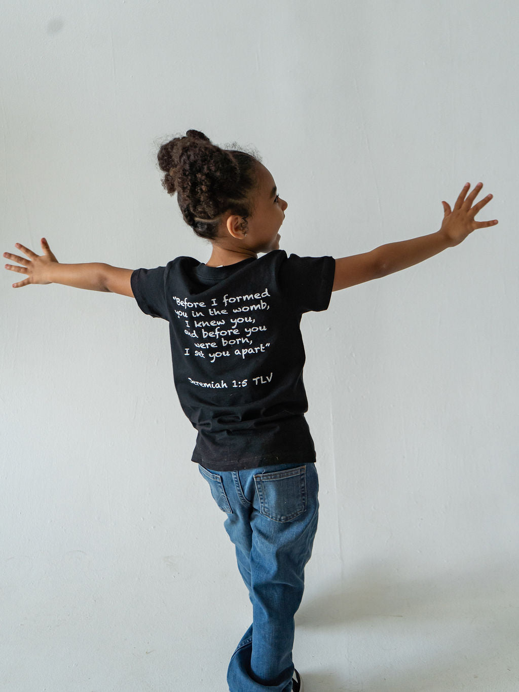 Black organic t-shirt  featuring "Before I Formed You" from Jeremiah 1:5, reminding every child they are known by God and created with purpose.