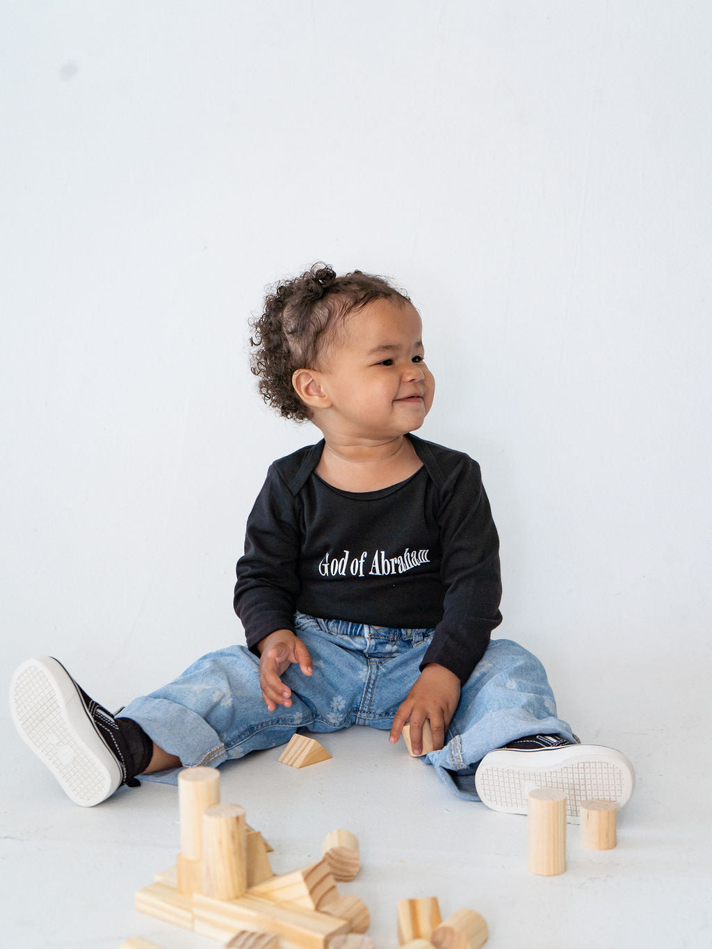 Black organic baby onesie featuring "Before I Formed You" from Jeremiah 1:5, reminding every child they are known by God and created with purpose.